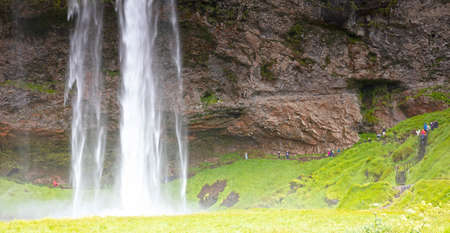 Seljalandfoss, Iceland - July 29, 2021: Seljalandsfoss is one of the best known waterfalls in Iceland. The waterfall drops 60 meters and is part of the Seljalands River that has its origin in the volcano glacier EyjafjallajÃ¶kull.のeditorial素材