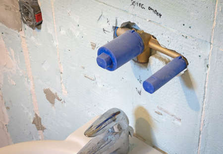 Building in a modern water tap in a plaster wall, under constructionの写真素材