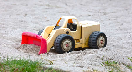 Dump truck toy working on the sand,.childrens toys