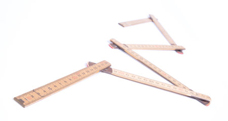Old folding wooden ruler, isolated on white