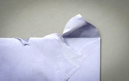 Torn (opened) envelope on a gray background