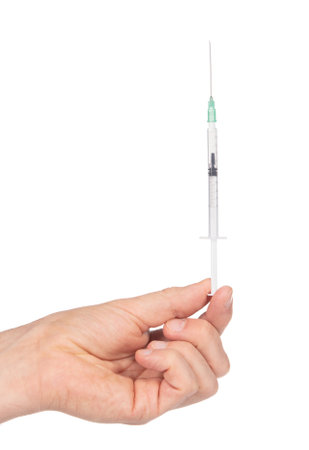 New syringe in adult hand on white background, medical and health care conceptの写真素材