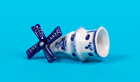 Vintage windmill figurine from Holland, isolated on blueの写真素材