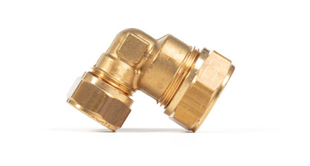 Brass fitting for plumbing pipes, connector for two different sizes, 90 degree angle, isolated on...
