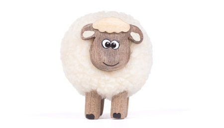 Miniature sheep, funny figurine, isolated on white backgroundの写真素材
