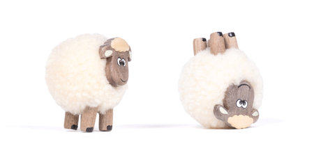 Miniature sheep, funny figurine, isolated on white backgroundの写真素材
