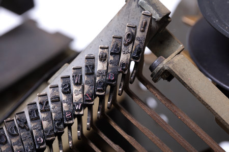 Broken metal typewriter, vintage object isolated, full frame