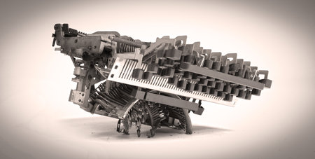 Broken metal typewriter, vintage object isolated, full frame