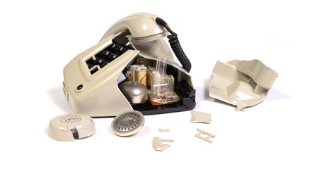 Part of a broken old telephone, phone with dial plate - plastic phone, isolatedの写真素材