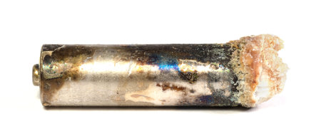Unbranded corroded alkaline battery leaking potassium hydroxide, isolatedの写真素材