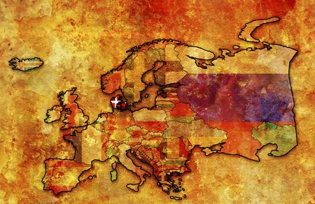 some very old grunge map of denmark with flag on map of europeの写真素材
