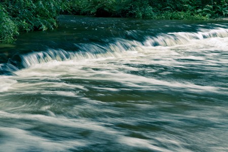scenic autumn or late summer landscape with river and waterfallsの写真素材