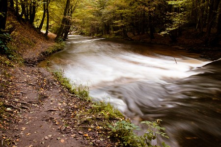 some small path near river in autumnの写真素材