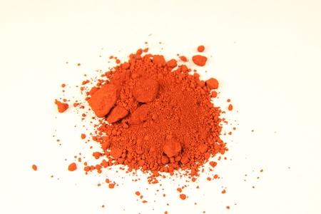 close up of a small portion of ferric red pigment isolated over whiteの写真素材