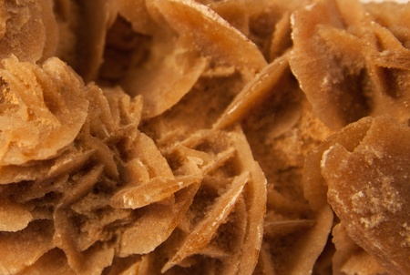 macro shot of stone called desert rose isolated over white backgroundの写真素材