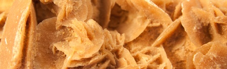 macro shot of stone called desert rose isolated over white backgroundの写真素材