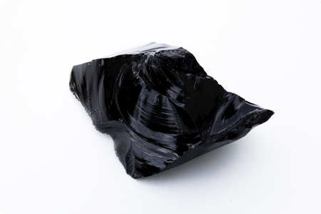 Extreme close up of Obsidian mineral isolated over white backgroundの写真素材