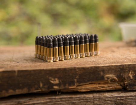 pack of ammunition for sport gun standing on a wooden plankの写真素材