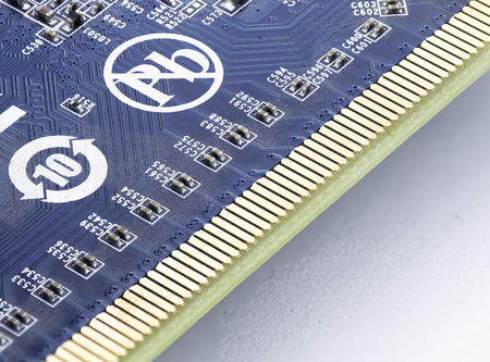 extreme close up of computer part with microcircuits in blue color and lead free symbol in focus...
