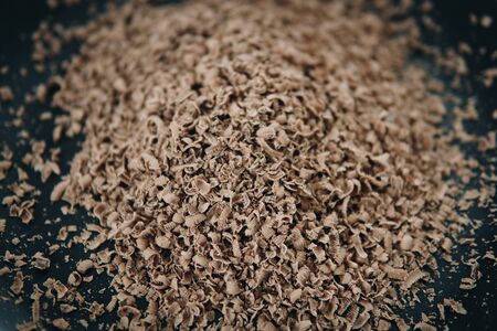detail of grated chocolate bar on a black plateの写真素材