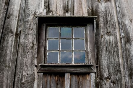 detail of old vintage window with square glasses over wooden wallの写真素材
