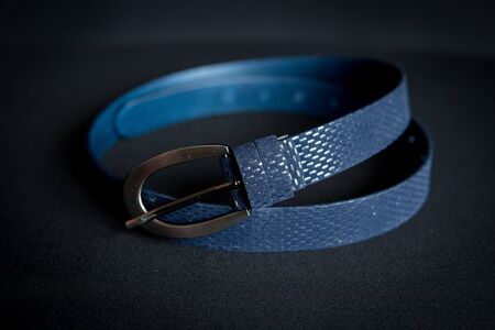 detail of a women's blue belt isolated over black backgroundの写真素材