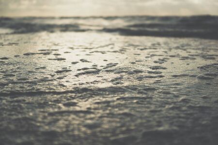 close up of sea waves on a sandy beach