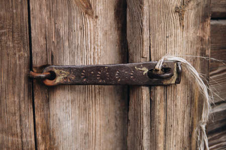 detail of an old wooden door with metal closingの写真素材