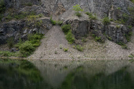 lake inside of a former sandstone quarry in Kielceの写真素材