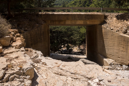 bridge over an empty valley of a small streamの写真素材