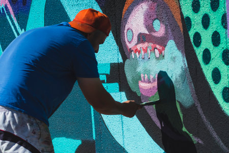 August 7, 2022, Lublin, Poland: Meeting of Styles - graffiti jam. Artist creating street art on the wallsのeditorial素材