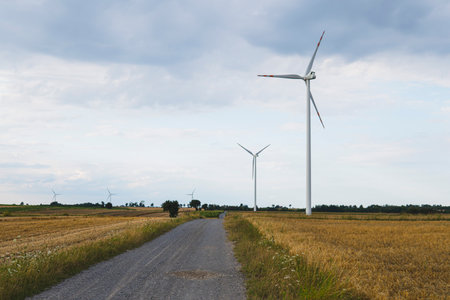 landscape with wind turbines generating power in the fieldの写真素材