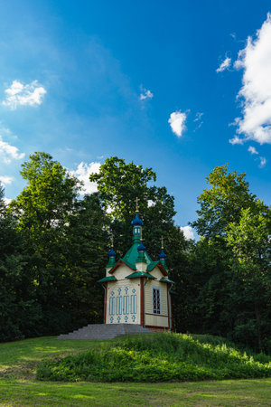 small Orthodox chapel on a small hill on the edge of the forestの写真素材