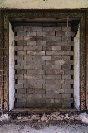 old entrance to former fortress walled with bricksの写真素材