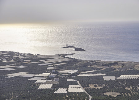Landscape with a coast where the famous Falasarna beach in Crete is located with white roofs of greenhousesの写真素材