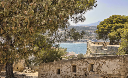 The walls of the Venetian fortress in the city of Rethymno in front of the Mediterranean seaの写真素材