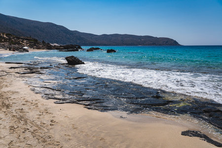 Landscape with single stones on the sandy coast of the Mediterranean Sea on the island of Creteの写真素材