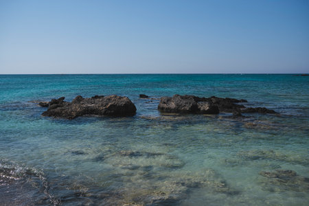 Landscape with single stones on the sandy coast of the Mediterranean Sea on the island of Creteの写真素材