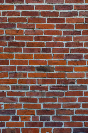 The texture of well-maintained red brick on the wall of a house