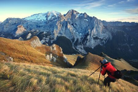 Amazing view of famous Dolomite peaks glowing in beautiful golden evening light at sunset in summer....