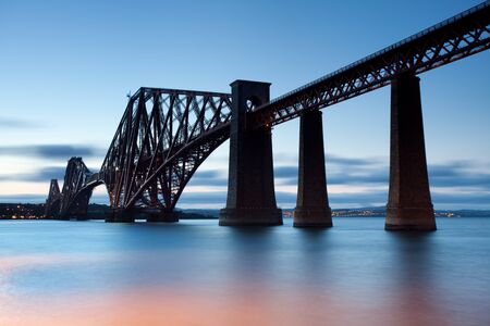 Rail Bridge over the Firth of Forth, crossing between Fife and Edinburgh at dusk, Scotland.