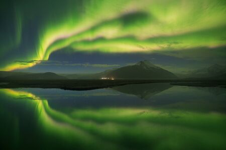 Aurora borealis. Jokulsarlon glacier lagoon, Iceland. Green Northern Lights. Starry sky with polar lights. Night winter landscape with aurora, sea with sky reflection in water. Natureの写真素材