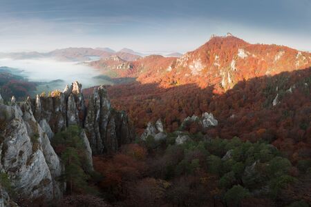 Autumn mountain forest rocks view. Mountain rocks in autumn forest. Autumn forest trees in rocks. Mountain forest in autumn landscape. Explore the beauty of the world Colorful landscape background conceptの写真素材