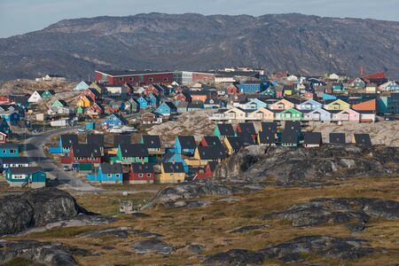 The colorful houses of Ilulissat, Greenland. This settlement is located on a small peninsula jutting...