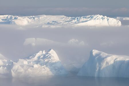 Iceberg at sunset. Nature and landscapes of Greenland. Disko bay. West Greenland. Summer Midnight...