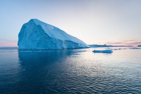 Greenland or Antarctica. Travel on ship among ices. Studying of global warming phenomenon Ices and icebergs of unusual forms and colorsの写真素材