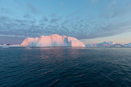 Greenland or Antarctica. Travel on ship among ices. Studying of global warming phenomenon Ices and...