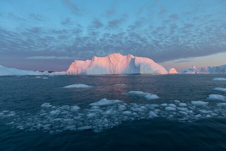 Greenland or Antarctica. Travel on ship among ices. Studying of global warming phenomenon Ices and icebergs of unusual forms and colorsの写真素材
