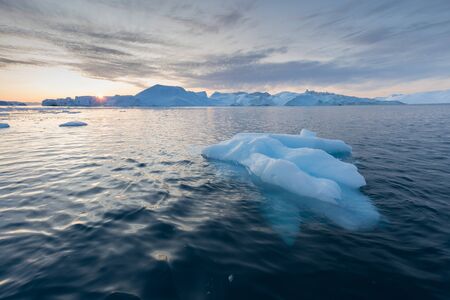Greenland or Antarctica. Travel on ship among ices. Studying of global warming phenomenon Ices and...