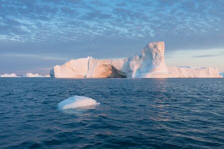 Greenland or Antarctica. Travel on ship among ices. Studying of global warming phenomenon Ices and icebergs of unusual forms and colorsの写真素材